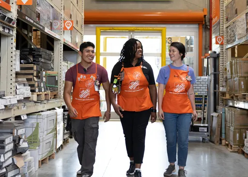 Home Depot store associates walking down an aisle together, representing retail store opportunities.