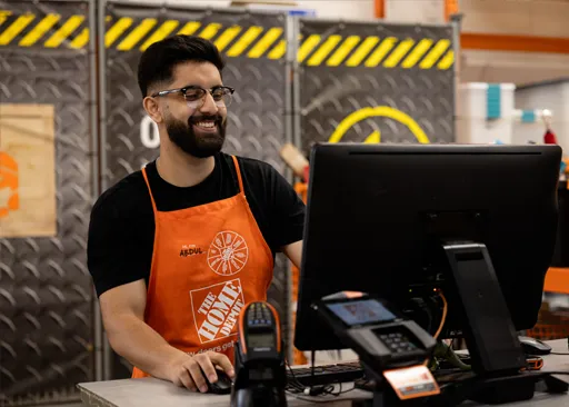 Home Depot store associates working in a welcoming store environment.